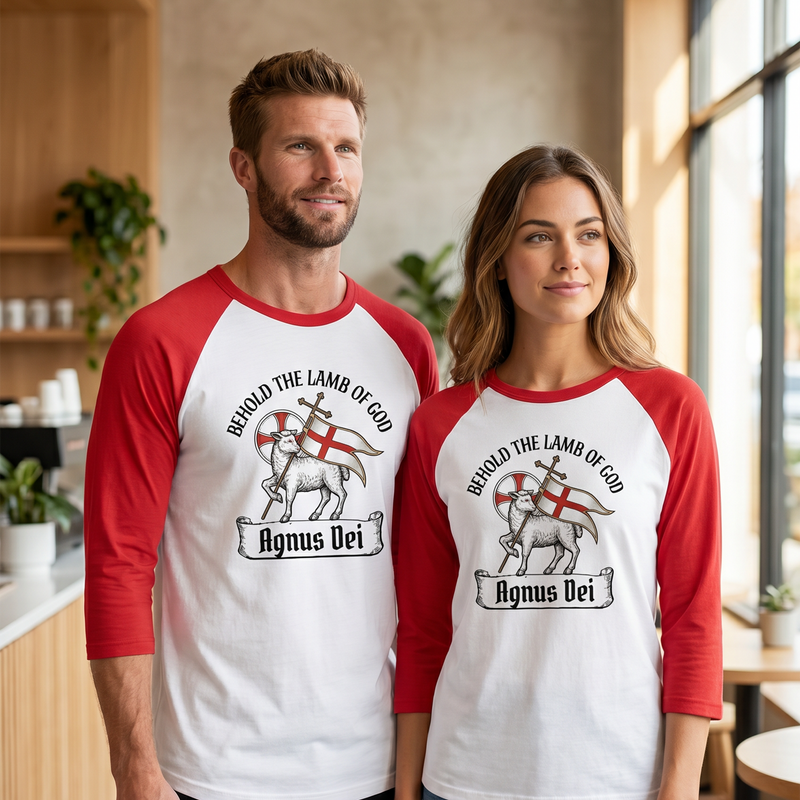 A man and woman wearing matching red and white raglan baseball tees featuring an Agnus Dei illustration with the text "Behold the Lamb of God." Perfect liturgical Lutheran apparel and Christian matching couple shirts for church members.