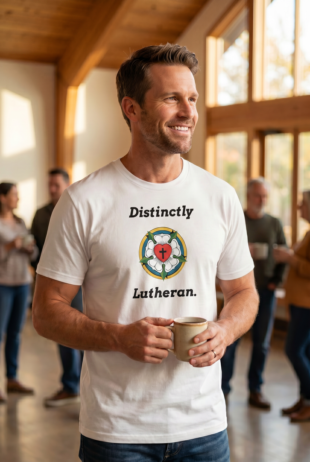 Smiling man holding a coffee mug at a church gathering wearing a white unisex Christian t-shirt with the 'Distinctly Lutheran' text and Luther Rose symbol. Faith-based apparel from Phoenix Anthem.