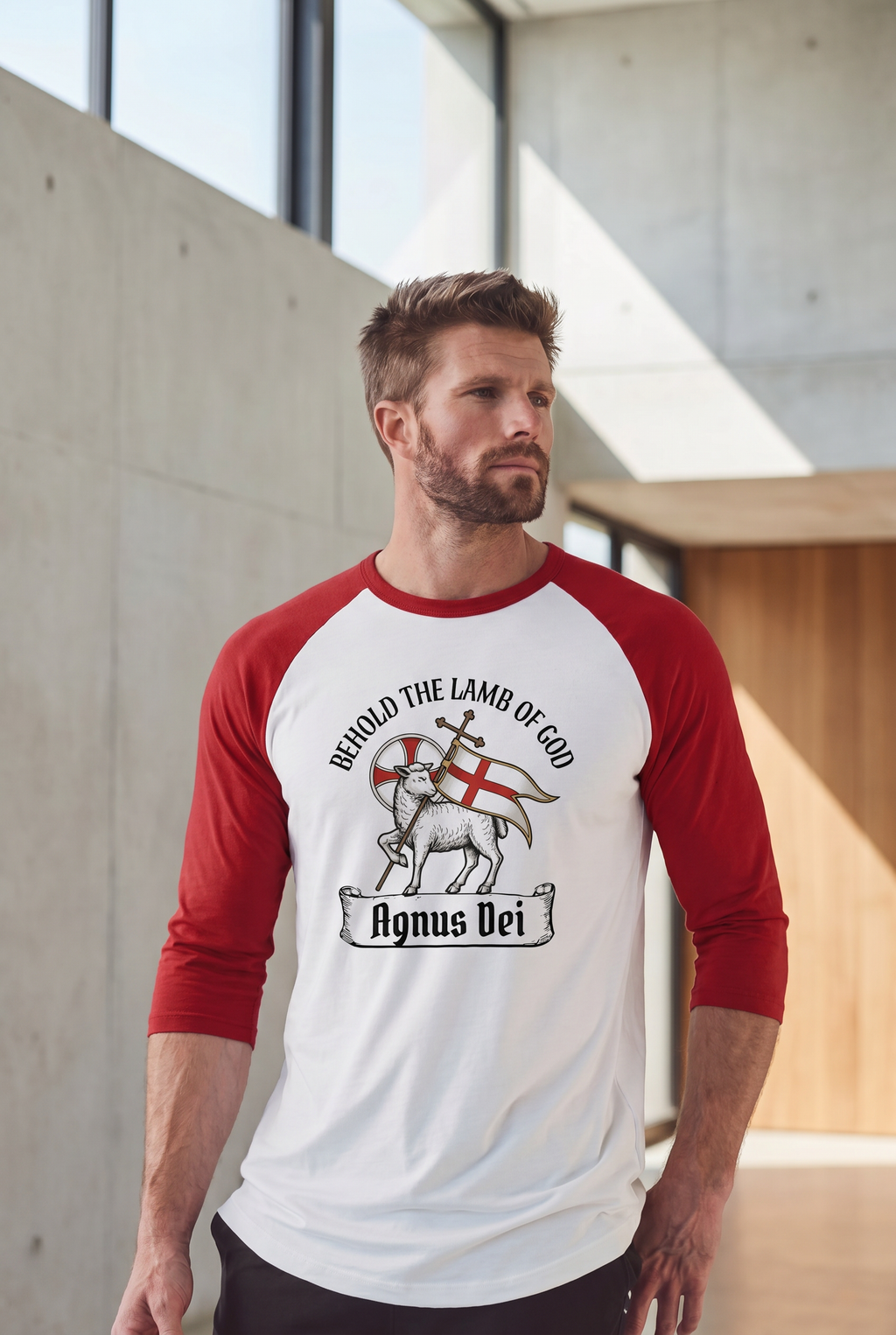 A man looking away while wearing a red and white 3/4 sleeve Christian baseball tee featuring a classic 'Agnus Dei' Lamb of God victory design. Theological Lutheran clothing from Phoenix Anthem.
