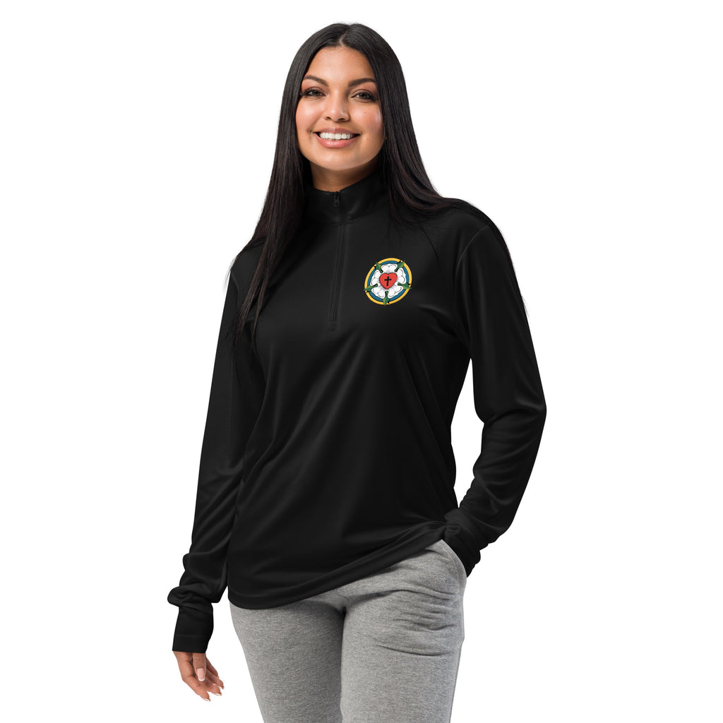 Close-up front view of a woman smiling and wearing the unisex black lightweight quarter-zip pullover showcasing the clean placement of the embroidered Luther Rose symbol.