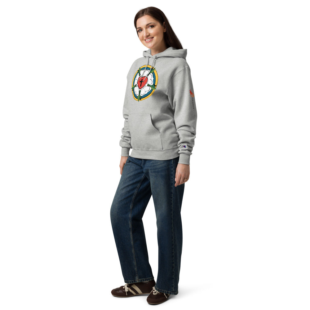 Full body shot of a woman in jeans and a light steel Champion Powerblend hoodie, demonstrating the cozy, everyday witness fit of the large Luther Rose apparel.