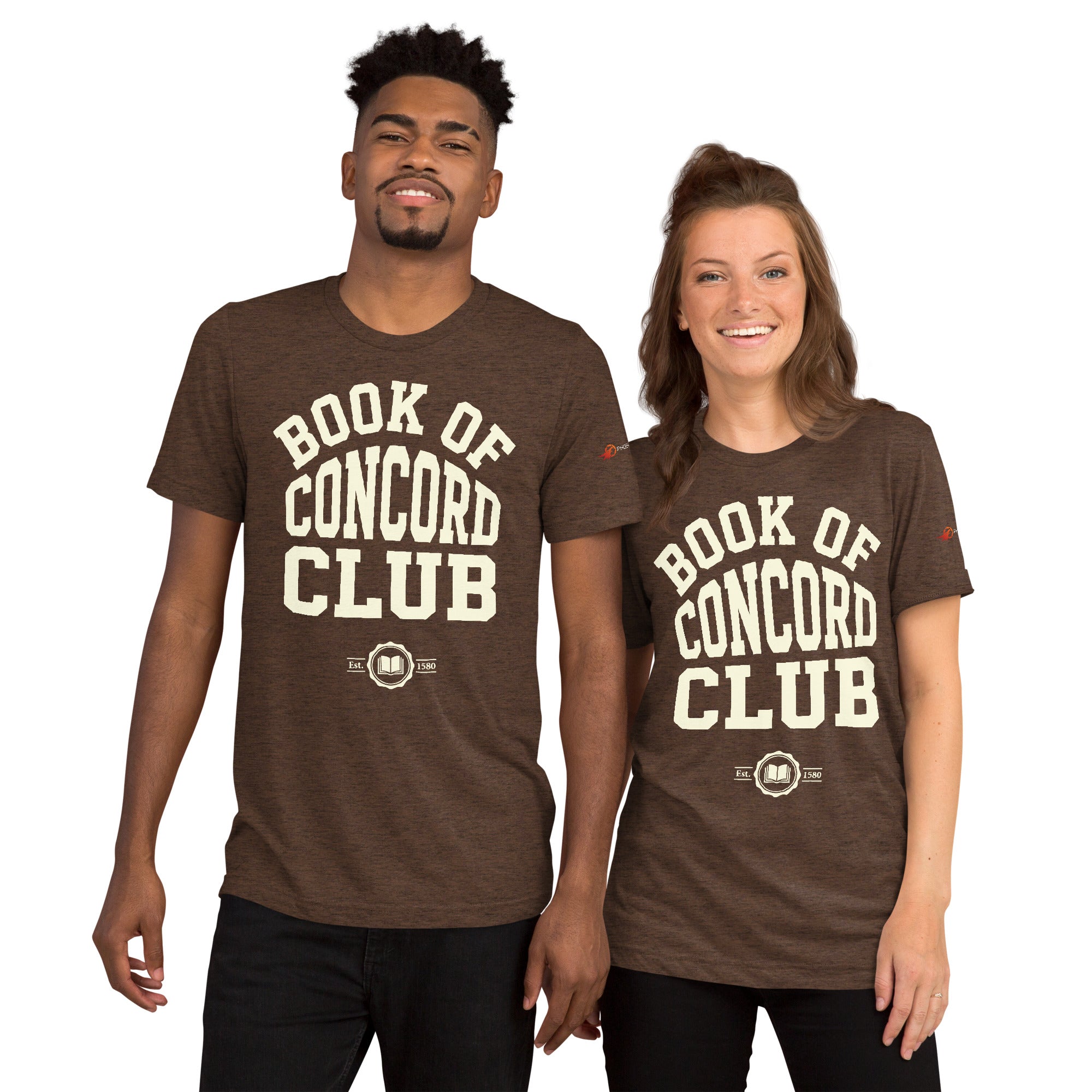A man and woman modeling matching brown tri-blend t-shirts featuring a collegiate "Book of Concord Club Est. 1580" graphic design. Premium Lutheran apparel and Christian theology clothing for men and women.