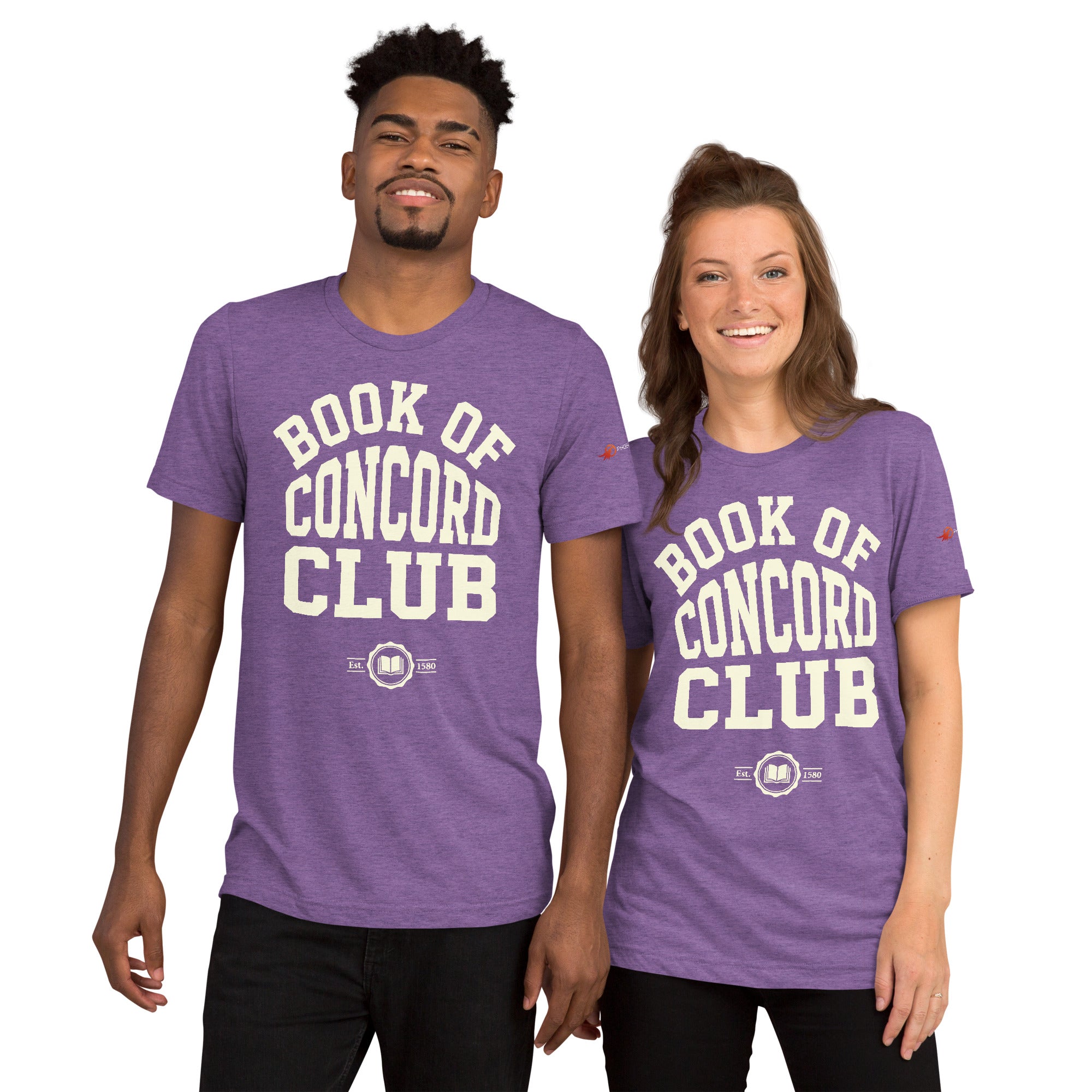 A man and woman modeling matching purple tri-blend t-shirts featuring a collegiate "Book of Concord Club Est. 1580" graphic design. Premium Lutheran apparel and Christian theology clothing for men and women.