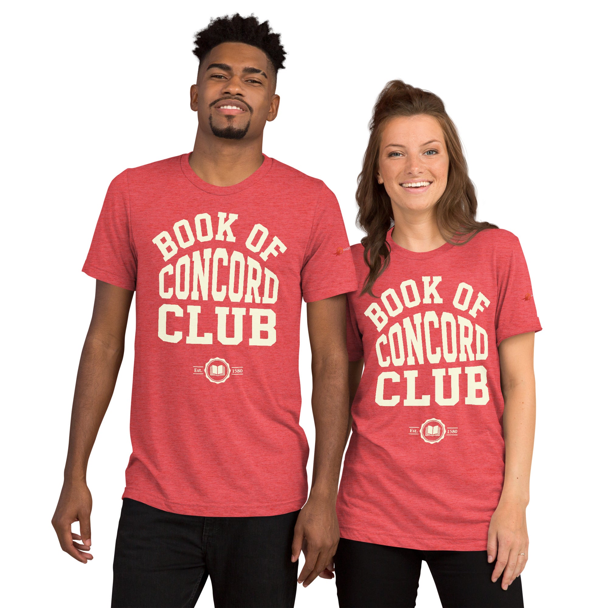A man and woman modeling matching red tri-blend t-shirts featuring a collegiate "Book of Concord Club Est. 1580" graphic design. Premium Lutheran apparel and Christian theology clothing for men and women.