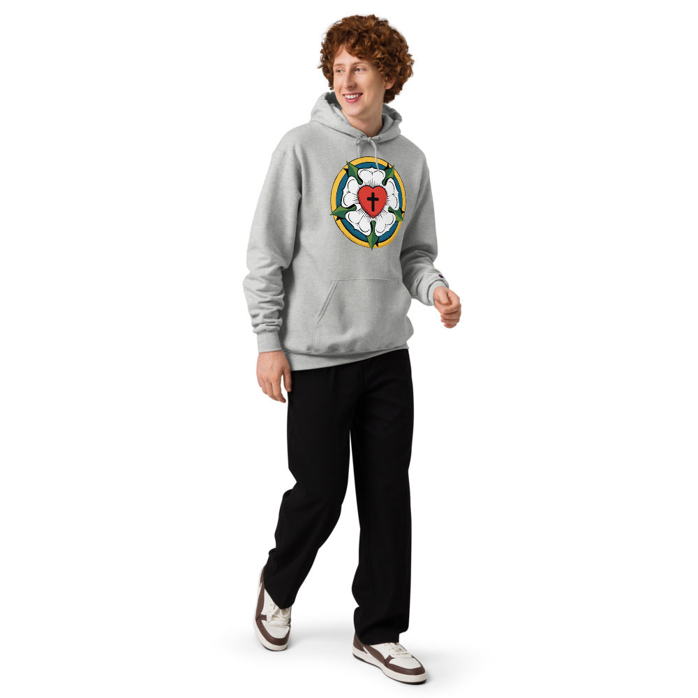 A young man walking and smiling in a light steel Champion hoodie, showing off the relaxed fit and bold theological design of our Lutheran store collection.
