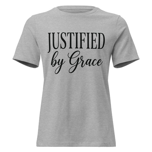 Front view of an athletic heather grey women's relaxed-fit Christian t-shirt with black text reading 'JUSTIFIED by Grace' in a clean serif and script font combination. Premium Lutheran faith-based apparel from Phoenix Anthem.
